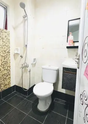 a bathroom with a toilet and a shower at Homestay Ustaz Lumayan in Kuala Lumpur
