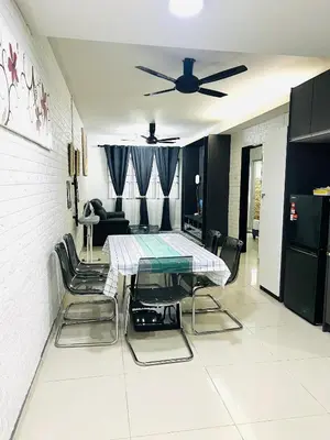 a dining room with a table and chairs in a room at Homestay Ustaz Lumayan in Kuala Lumpur