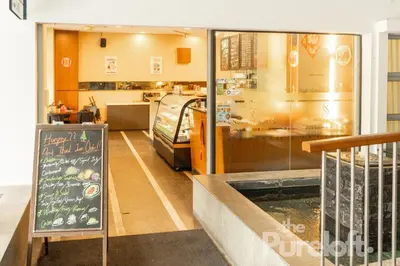 a restaurant with a chalkboard in front of a counter at Suasana by TPL - Bukit Bintang KLCC in Kuala Lumpur