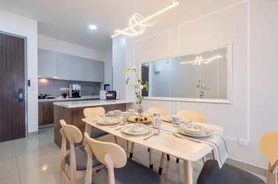 a dining room with a table and chairs at M Vertica w Infinity Pool Mrt TRX Sunway Velocity in Kuala Lumpur