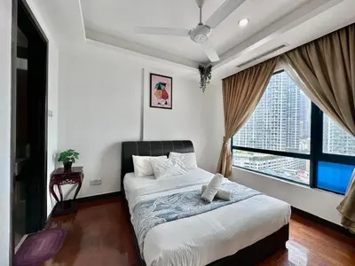 a bedroom with a bed and a large window at Casa Residency in Kuala Lumpur