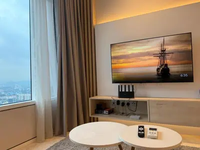 a living room with a tv on a wall at Majestic Residence KLCC in Kuala Lumpur