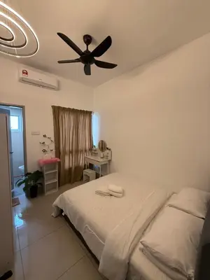 a bedroom with a bed with a ceiling fan at Razak City Residence KL City in Kuala Lumpur