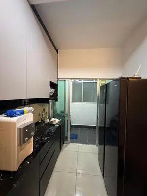 a kitchen with a black refrigerator and a sink at Razak City Residence KL City in Kuala Lumpur