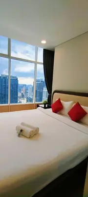 a hotel room with a bed with a large window at Sky Suites KLCC by TD Luxe Global in Kuala Lumpur