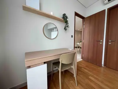 a dining room with a wooden table and a mirror at Nook Sky Suites KLCC in Kuala Lumpur