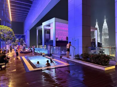 a group of people in a swimming pool in a building at Platinum Suites Kuala Lumpur Malaysia By LuzBnB in Kuala Lumpur