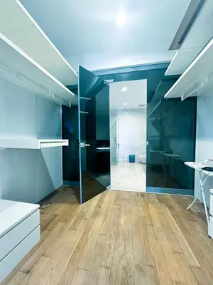 a large bathroom with blue walls and wooden floors at Platinum Suites Kuala Lumpur Malaysia By LuzBnB in Kuala Lumpur