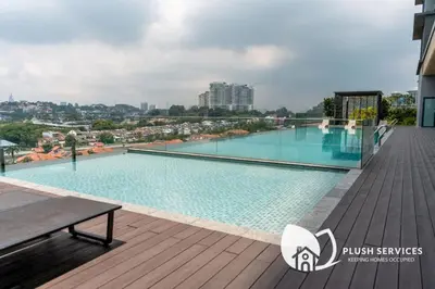 a swimming pool on the roof of a building at Societe Suites Hartamas by Plush in Kuala Lumpur