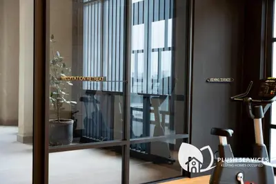 a sliding glass door with a view of a room at Societe Suites Hartamas by Plush in Kuala Lumpur