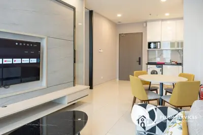 a living room with a tv and a table and chairs at Societe Suites Hartamas by Plush in Kuala Lumpur