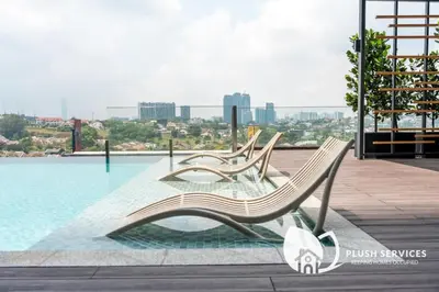 two benches sitting next to a pool on a building at Societe Suites Hartamas by Plush in Kuala Lumpur