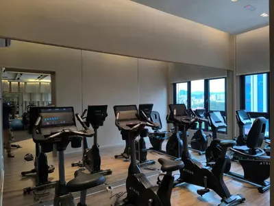 a gym with rows of exercise bikes and treadmills at Sky View Agile Residence Bukit Bintang KL in Kuala Lumpur