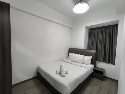 a small bedroom with a bed with a white blanket at Sky View Agile Residence Bukit Bintang KL in Kuala Lumpur