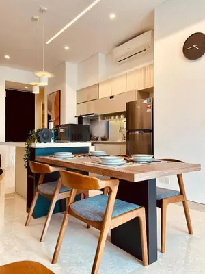 a kitchen with a large wooden table and chairs at Lucentia Residences By ONZO in Kuala Lumpur