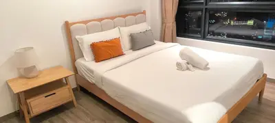 a bedroom with a large white bed with a window at Service Residence Agile Delima Residence KL in Kuala Lumpur