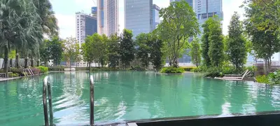 a large pool of water with trees and buildings at Service Residence Agile Delima Residence KL in Kuala Lumpur