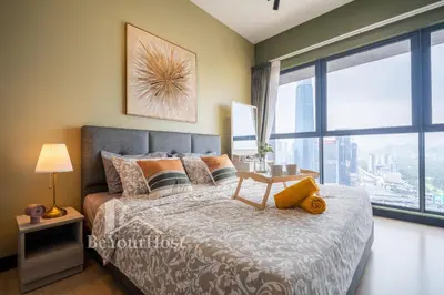 a bedroom with a bed and a large window at Continew Residences Kuala Lumpur in Kuala Lumpur