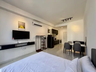 a bedroom with a bed and a table with chairs at The Majestic Residence Kuala Lumpur in Kuala Lumpur