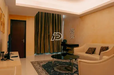a living room with a couch and a table at KL Hartamas 2BR Wifi Smart TV in Kuala Lumpur