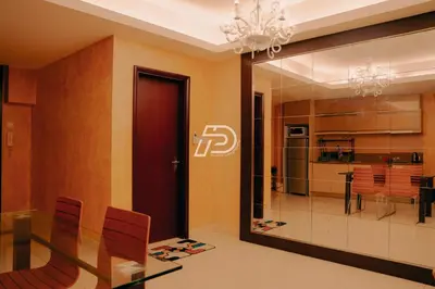 a dining room with a chandelier and a glass door at KL Hartamas 2BR Wifi Smart TV in Kuala Lumpur