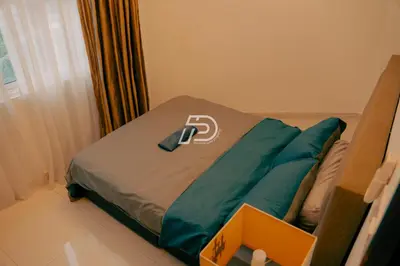 a bed in a room with a pillow on it at KL Hartamas 2BR Wifi Smart TV in Kuala Lumpur
