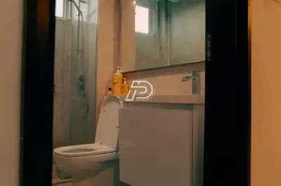 a bathroom with a toilet and a shower and a sink at KL Hartamas 2BR Wifi Smart TV in Kuala Lumpur