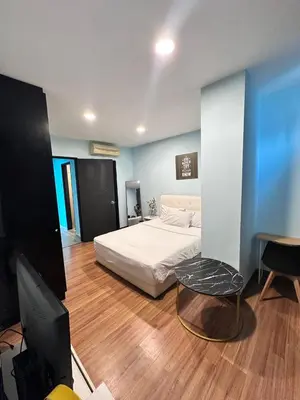 a bedroom with a bed and a flat screen tv at Taragon Puteri Bintang KL in Kuala Lumpur