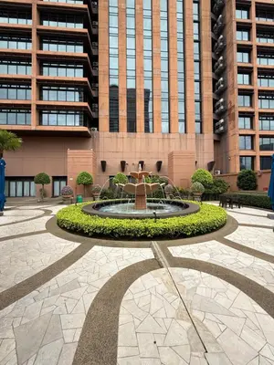 a fountain in a courtyard in front of a building at Times Square KL Serviced Suite in Kuala Lumpur