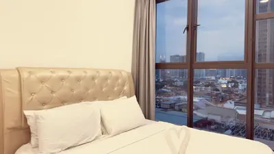 a bedroom with a bed and a large window at Cozy couple suite 1601A at KLCC in Kuala Lumpur