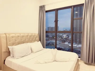a white bed in a room with a large window at Cozy couple suite 1601A at KLCC in Kuala Lumpur