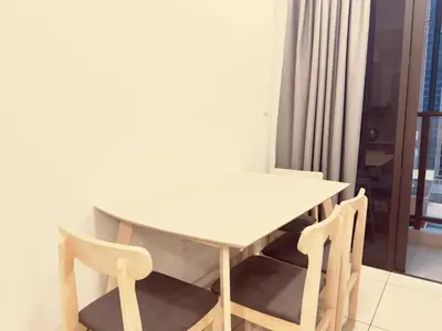 a white table and chairs in a room with a window at Cozy couple suite 1601A at KLCC in Kuala Lumpur