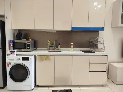 a kitchen with a washing machine and a microwave at Quill Residence KLCC Suites City Home in Kuala Lumpur