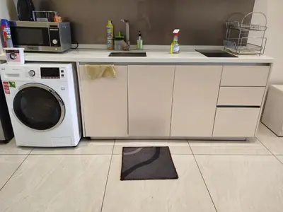 a kitchen with a sink and a washing machine at Quill Residence KLCC Suites City Home in Kuala Lumpur