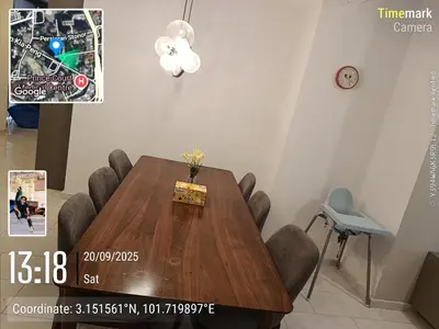 a dining room table with chairs and a clock at Eaton resident full luxury in Kuala Lumpur