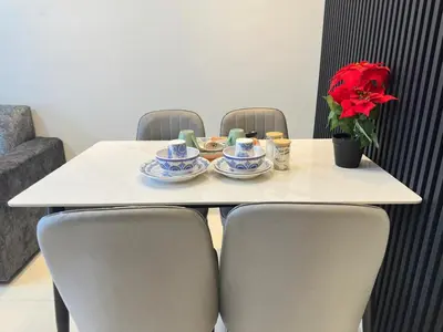 a table with chairs and a plate of food on it at Luxury couple suite 1906B at KLCC in Kuala Lumpur