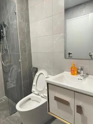 a bathroom with a toilet and a sink and a shower at Luxury couple suite 1906A at KLCC in Kuala Lumpur