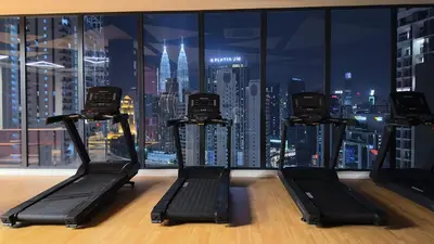 a gym with a view of a city skyline at Luxury couple suite 1906A at KLCC in Kuala Lumpur
