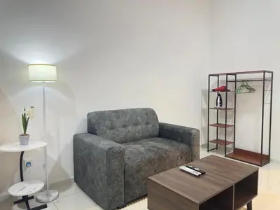 a living room with a couch and a coffee table at KLCC view suite 1601B at Majestic Residence in Kuala Lumpur