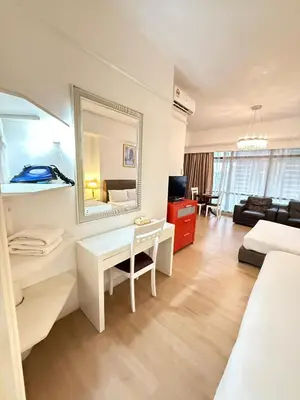 a living room with a bed and a mirror at Signature Suite at Time Square by Regal in Kuala Lumpur
