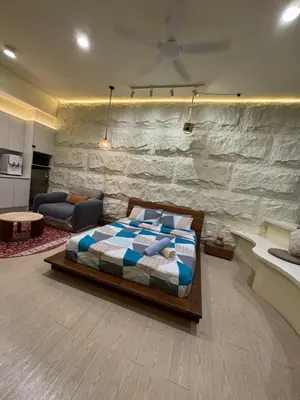 a bedroom with a bed and a stone wall at PWTC Chamber Rock by AZ Line in Kuala Lumpur