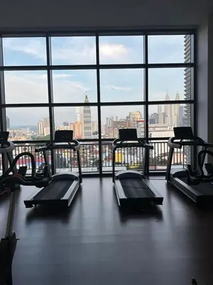 a gym with three treadmills and a large window at PWTC Chamber Rock by AZ Line in Kuala Lumpur