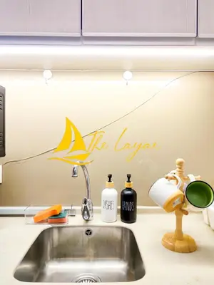 a kitchen sink with a fish painting on the wall at Swiss Garden Residence by The Layar Homes in Kuala Lumpur