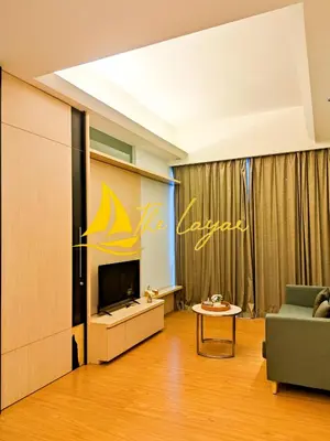 a living room with a tv and a couch and a table at Swiss Garden Residence by The Layar Homes in Kuala Lumpur