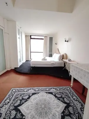 a bedroom with a bed and a large rug at Grand Lumia Suite At Times Square KL in Kuala Lumpur