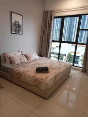 a bed with a black suitcase on it in a bedroom at Trion Comfort & Luxury Near By Klcc in Kuala Lumpur