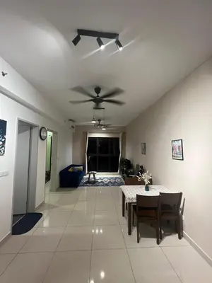 a living room with a table and a ceiling fan at Trion Comfort & Luxury Near By Klcc in Kuala Lumpur