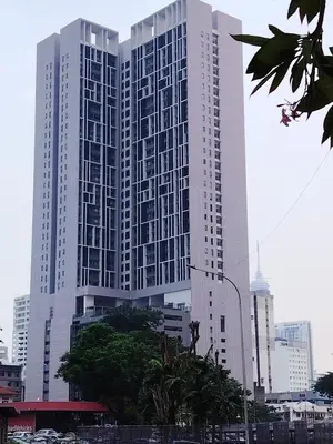 a large white building in the middle of a city at SUITES At CHAMBERS KLCC KUALALAMPUR in Kuala Lumpur