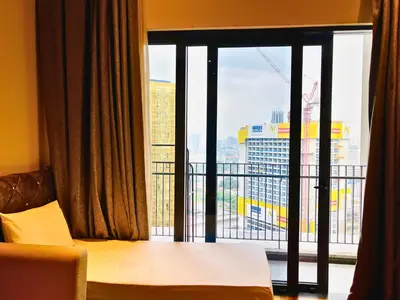 a room with a window with a view of a city at The Mews KLCC Service Suites in Kuala Lumpur