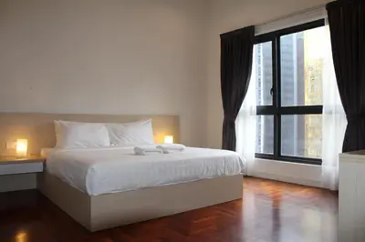 a bedroom with a bed and a large window at The Mews KLCC Service Suites in Kuala Lumpur